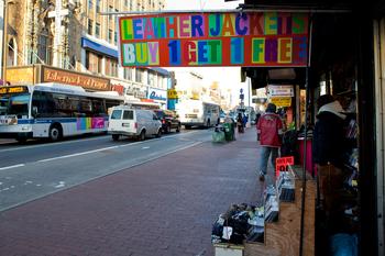 Brightly colored signs, such as this, line Jamaica Ave.